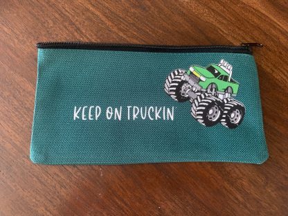 green monster truck pencil case with saying: keep on trucking