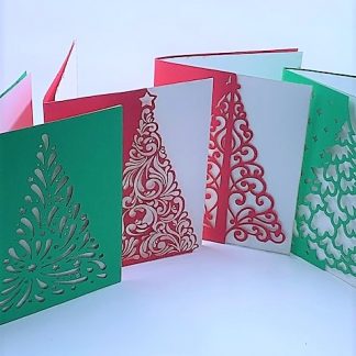Four laser cut cards with christmas tree pattern in red and green.