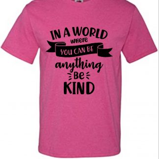 pink tshirt with the words 'in a world where you can be anything, be kind' in black vinyl