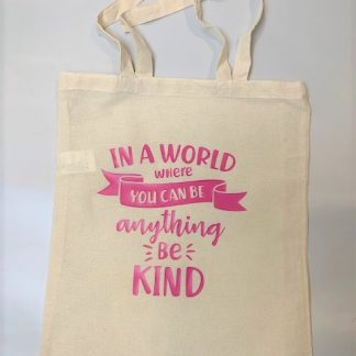 canvas tote with 'in a world where you can be anything, be kind' in pink vinyl