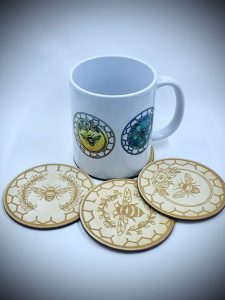 mug with colour bee print design and laser cut wooden bee coasters set 
