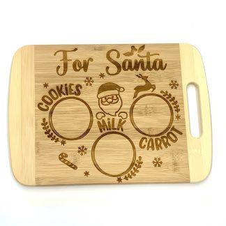 Small wooden cutting board with For Santa engraved on it. With a spot for cookies, milk and carrots