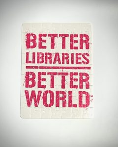 Cardboard puzzle with sublation image on it. "Better Libraries, Better world in pink